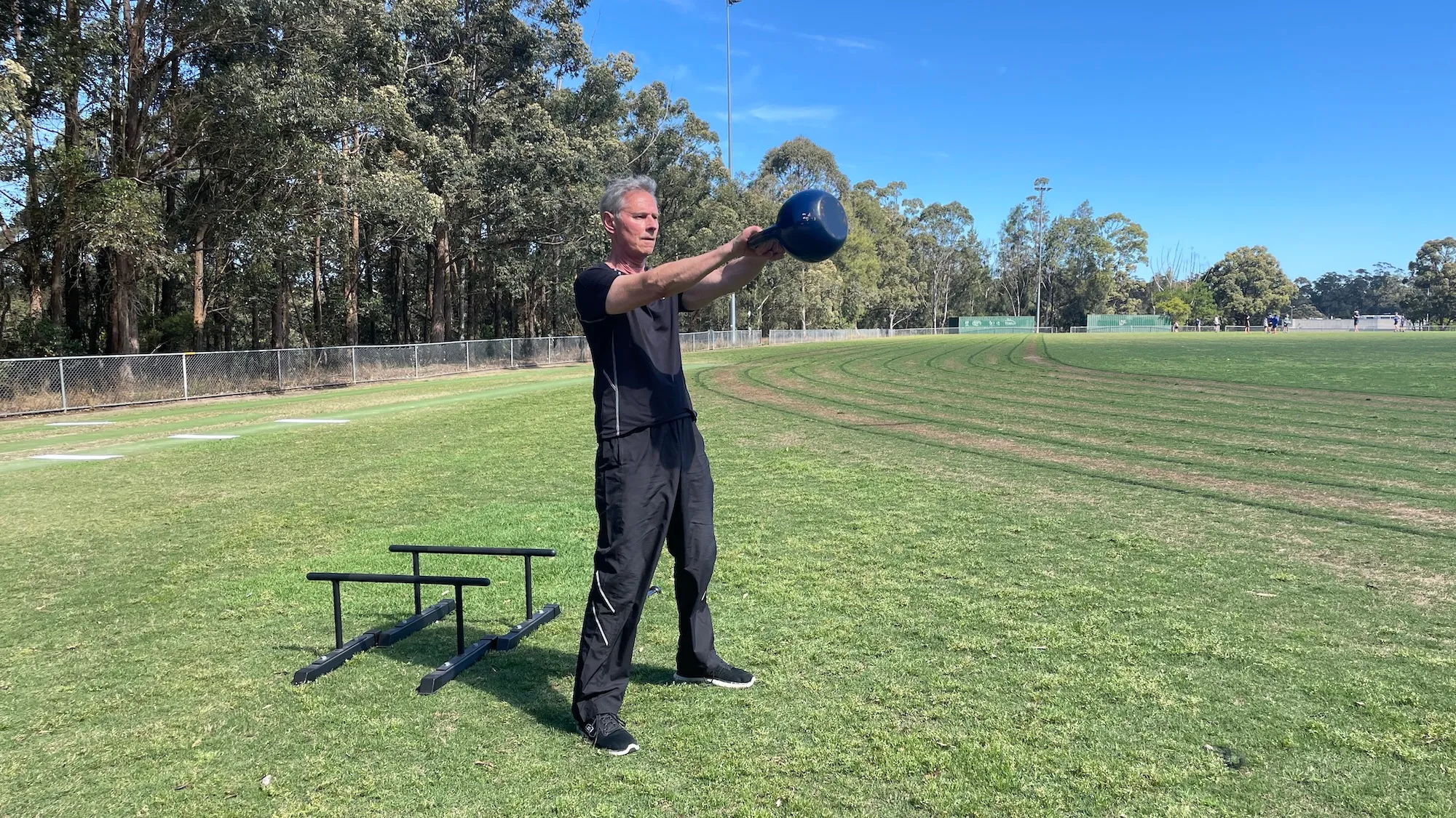 George swinging a kettlebell